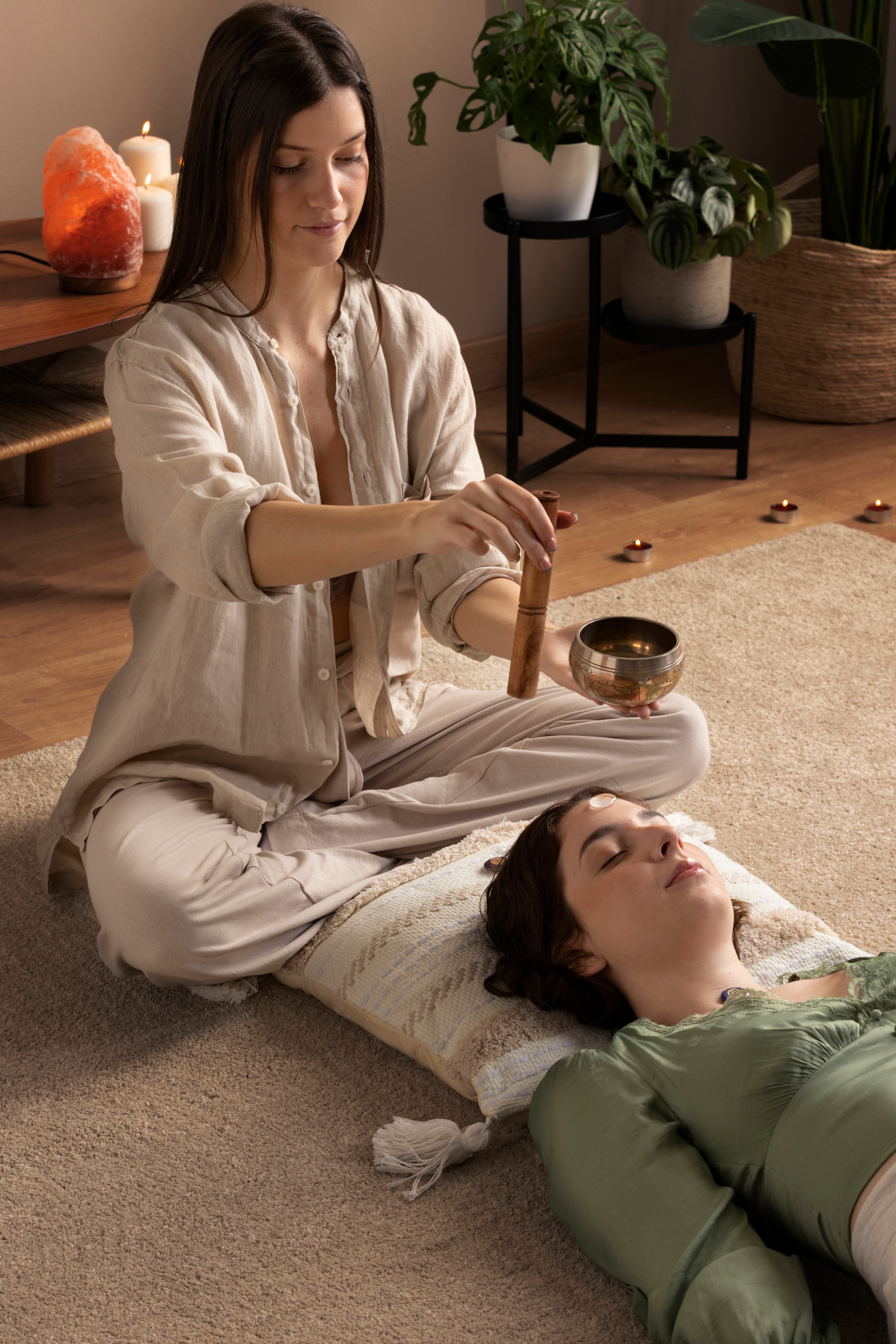 Meditation setup with Buddha statue, sage bundle, singing bowl, and crystals