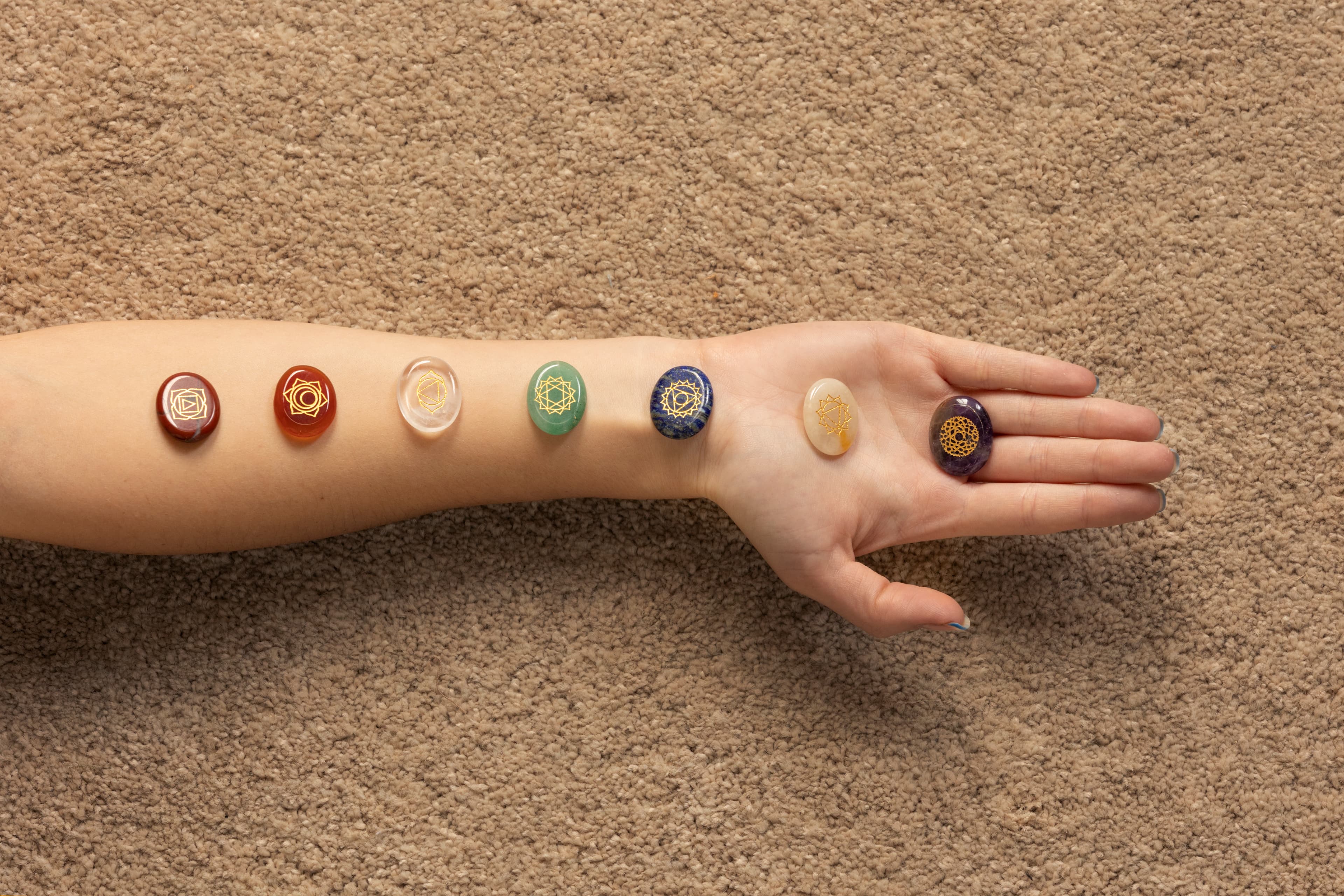 Hand with chakra crystals
